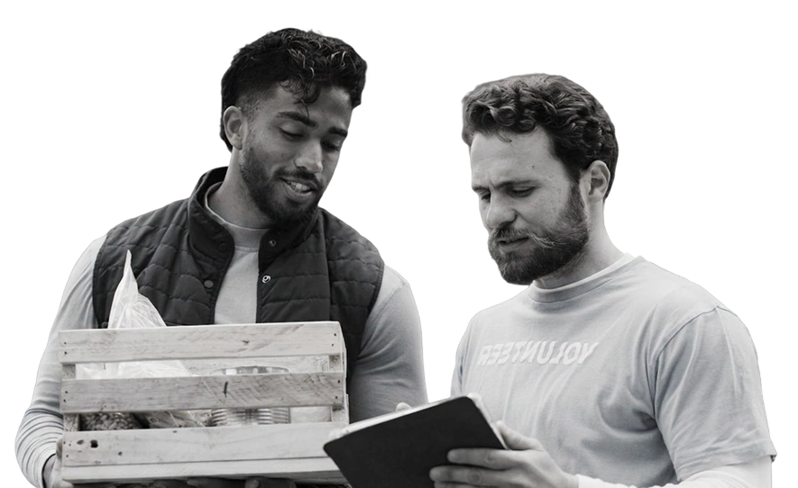 Salesforce professionals collaborating with laptop showing Ksolves and Salesforce logos